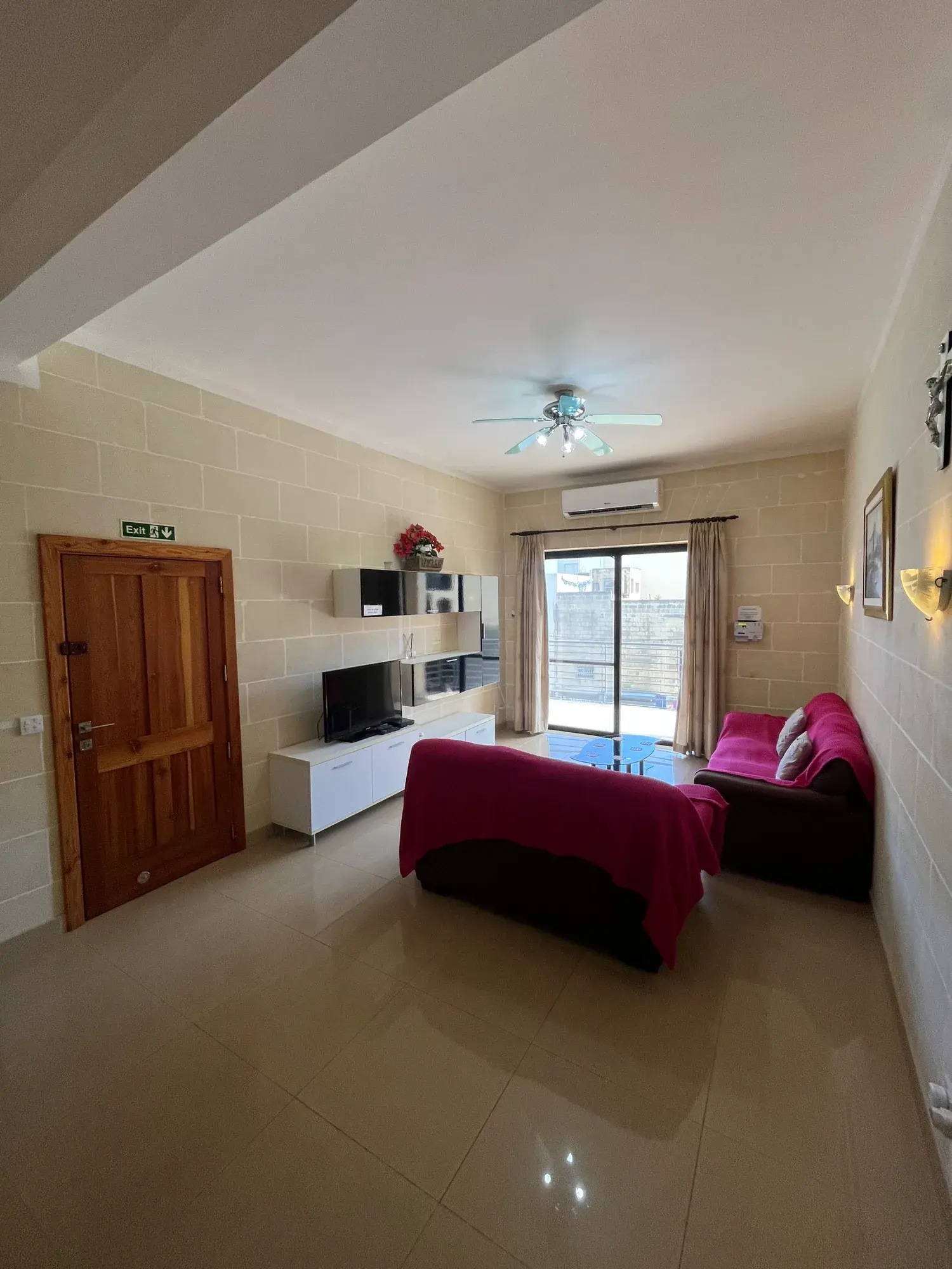 Bright living room with burgundy sofas at Vicmar Apartment 2